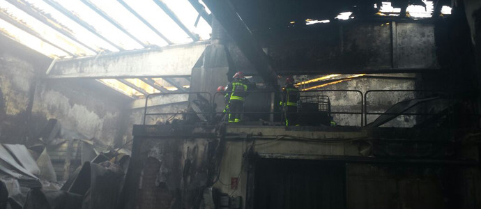 Bomberos del 112 sofocan un incendio en una nave de conservas en Santoa